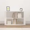 A white sideboard with books and an alarm clock on top, set against a white wall. Náhľad obrázku produktu