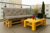 A balcony setting with a pallet sofa and a yellow coffee table. Produktbild-Vorschau