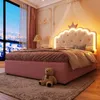 A child's bedroom with a pink bed, a teddy bear, and a city view outside the window. Náhled obrázku produktu