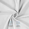 A close-up shot of white fabric, likely a pillowcase, with two circular icons and text indicating product features. Produktbild-Vorschau
