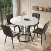 A round dining table with four chairs in a well-lit room.