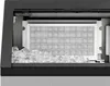 Close-up view of the interior of an ice maker, showing the ice cube tray and a pile of ice cubes. Produktbild-Vorschau