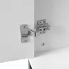Close-up of a cabinet hinge attached to two white cabinet doors. Anteprima dell’immagine prodotto