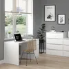 A modern home office setup with a white desk, chair, and storage units. Náhľad obrázku produktu