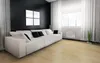 A modern living room with a large white sofa, black wall, and white curtains. Produktbild-Vorschau