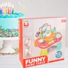 A birthday cake with candles and a toy product box. Produktbild-Vorschau
