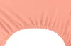 A close-up view of a peach-colored fitted sheet with elastic gathering at the edge. Produktbild-Vorschau