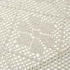 A close-up view of a beige crocheted tablecloth with a diamond pattern. Náhľad obrázku produktu