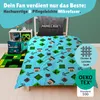 A Minecraft-themed bedding set is displayed on a bed, with accompanying accessories like a rug and pillows. The scene is set in a child's bedroom. Produktbild-Vorschau