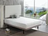 A bedroom scene with a bed, headboard, and a large window overlooking a scenic view. Produktbild-Vorschau