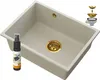 A beige sink with gold fixtures and a cleaning spray bottle. Podgląd zdjęcia produktu