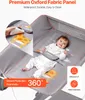A baby lying on a gray changing table with cartoon giraffe graphics. Voir les images du produit