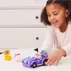 A young girl plays with a purple toy car on a white table, with a dresser in the background. Anteprima dell’immagine prodotto
