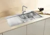 A modern stainless steel kitchen sink with a faucet and a small bowl with chopsticks on the countertop. Podgląd zdjęcia produktu