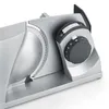 Close-up of a food slicer with a focus on the blade and the adjustment dials. Voir les images du produit