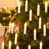 A close-up view of a decorated Christmas tree with LED candle lights and a bell ornament. Náhľad obrázku produktu
