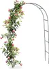 A metal garden arch covered in pink roses and green foliage, set against a plain white background. Podgląd zdjęcia produktu