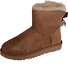 A single brown Ugg boot with a bow on the back, shown against a white background. Produktbild-Vorschau