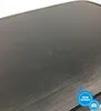 A close-up of the surface of a black appliance, showing scratches and dust. Produktbild-Vorschau