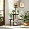 A multi-tiered plant stand filled with various plants and flowers, placed indoors near a window with sunlight streaming in. Náhľad obrázku produktu
