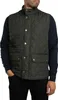 A man wearing a green quilted vest over a navy sweater. Produktbild-Vorschau
