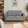 A living room scene with a gray sofa, a bookshelf, and a plant. Produktbild-Vorschau