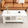 A white coffee table with items on it, placed in front of a brown leather sofa. Produktbild-Vorschau