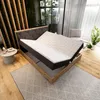 A bedroom scene with a bed, rug, and plants. Produktbild-Vorschau