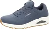 A side view of a navy blue Skechers sneaker with a white sole and brown outsole. Náhled obrázku produktu