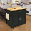A black kitchen cart with a wooden top is shown in a kitchen setting. Voir les images du produit