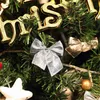 Close-up of Christmas tree decorations including bows and ornaments. Náhľad obrázku produktu