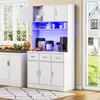 A white kitchen cabinet with LED lighting, displaying kitchen appliances and decorative items. Produktbild-Vorschau