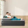 A couple relaxing on an inflatable air mattress in a living room. Produktbild-Vorschau
