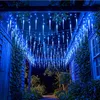 Icicle lights are strung across a covered outdoor walkway at night. Produktbild-Vorschau