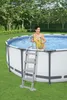A woman in a yellow swimsuit is climbing out of an above-ground swimming pool using a ladder. Produktbild-Vorschau
