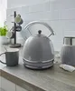A kitchen counter with a kettle, mug, and other accessories. Produktbild-Vorschau