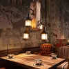 A rustic dining table setting with a vintage chandelier. Náhled obrázku produktu