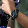 A person wearing a Casio Edifice watch while riding a motorcycle. Voir les images du produit