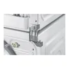 Close-up view of the rear of stacked appliances, showing a connecting bracket. Podgląd zdjęcia produktu