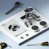 A bathroom faucet and its installation components are laid out on a marble surface, with tools nearby. Produktbild-Vorschau