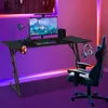 A gaming desk setup with a computer, keyboard, mouse, speakers, headphones, and a gaming chair, illuminated by colorful LED lighting. Produktbild-Vorschau