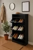 A shoe cabinet with shoes and a coat rack with a coat in a room. Produktbild-Vorschau