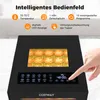 A close-up view of a black food dehydrator with sliced tomatoes on trays inside, and a hand touching the control panel. Podgląd zdjęcia produktu