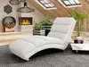 A modern living room with a chaise lounge, fireplace, and plants. Náhľad obrázku produktu