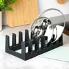 A black pot lid organizer holding two pot lids on a kitchen counter. Anteprima dell’immagine prodotto
