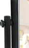 A close-up of a black stand with a knob and a lever, with a blurred background of a chair and wallpaper. Anteprima dell’immagine prodotto