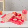 A lunchbox set and a water bottle are arranged on a table. Podgląd zdjęcia produktu