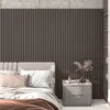 A bedroom scene featuring a bed with acoustic panels on the wall behind it and a nightstand next to the bed. Produktbild-Vorschau
