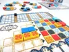 A close-up view of the board game 'Azul' with colorful tiles arranged on player boards and a central scoring track. Anteprima dell’immagine prodotto