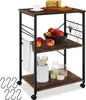A kitchen cart with food and kitchenware on it.